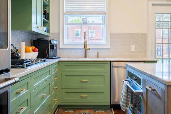 Example photo: green painted kitchen cabinets around a window