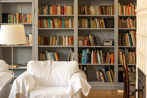Example photo: a wall of built-in bookshelves behind an armchair