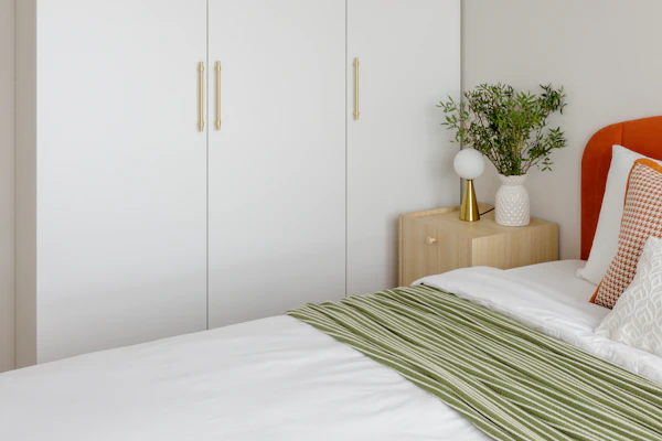 Example photo: a bedroom with white built-in wardrobes beside the bed