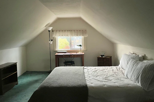 Example photo: a loft room with a window in the gable and sloping walls