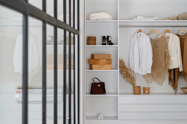 Example photo: a white walk-in wardrobe with shelves and a hanging rail